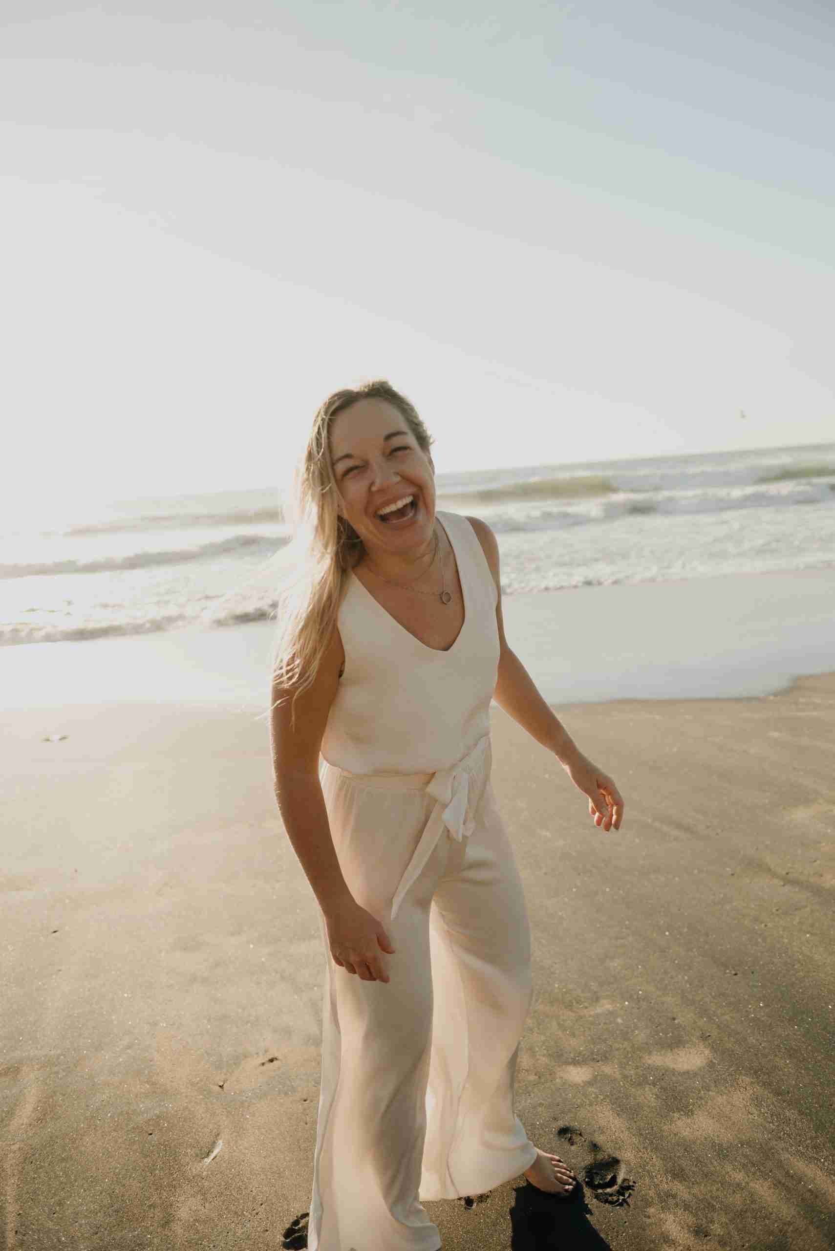 Jen Roberts smiling warmly on the beach